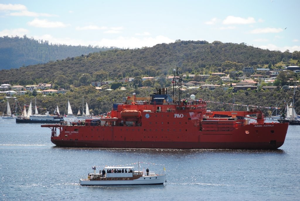 The Antartic supply vessel Aurora Australis leads the Mawson Centenary Flotilla as the Governor of Tasmania, Mr Peter Underwood, takes the salute aboard the historic motor launch Egeria off Hobart’s Regatta Point © Rob Cruse